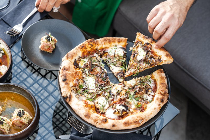 Truffle mushroom specialty pizza with arugula