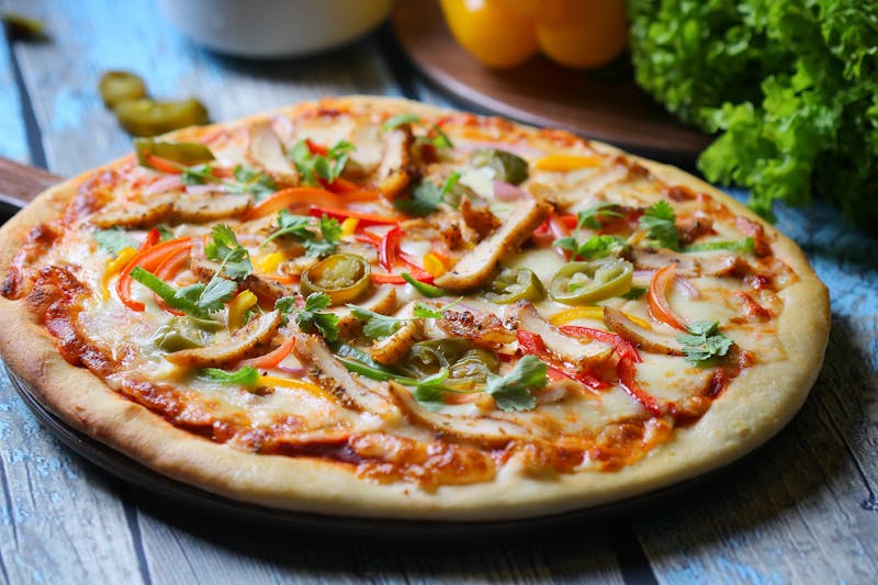 Pesto chicken specialty pizza with sun-dried tomatoes