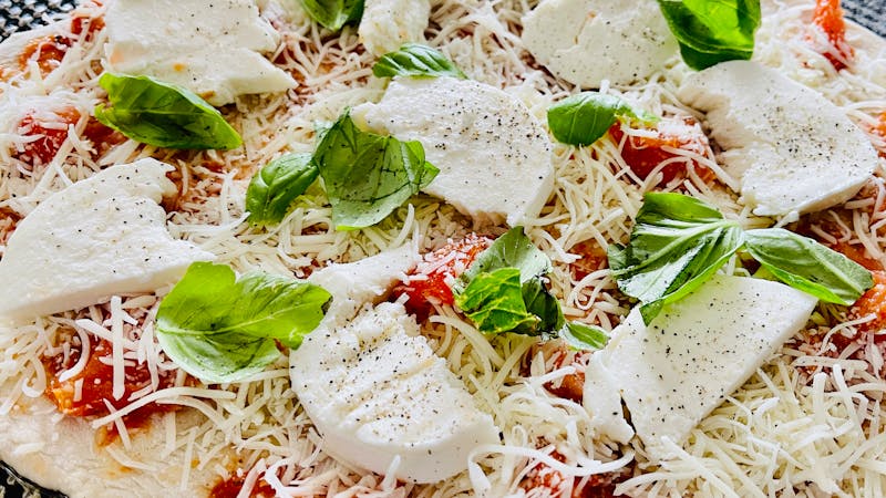Classic Margherita round table pizza with fresh mozzarella and basil