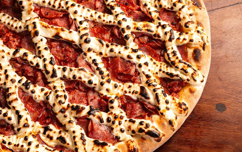 Pepperoni pizza with crispy edges on round table